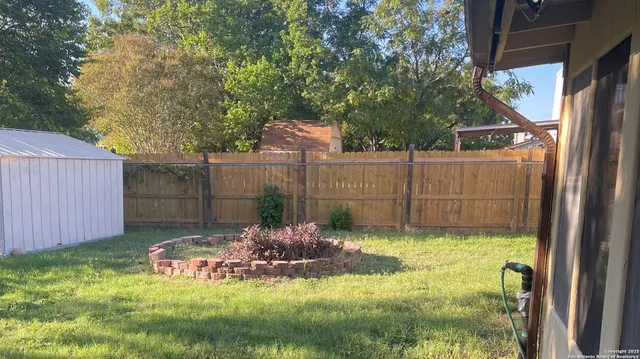 a view of outdoor space with wooden fence