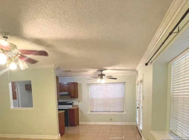 a view of a kitchen with kitchen island and windows