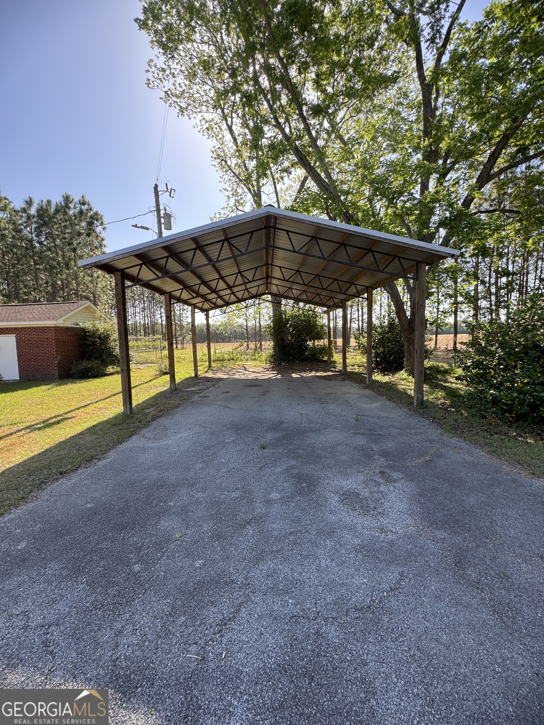 7290 Nevils Groveland Road Pembroke, GA 31321 - Photo 13 of 45 a view of a house with backyard and a tree