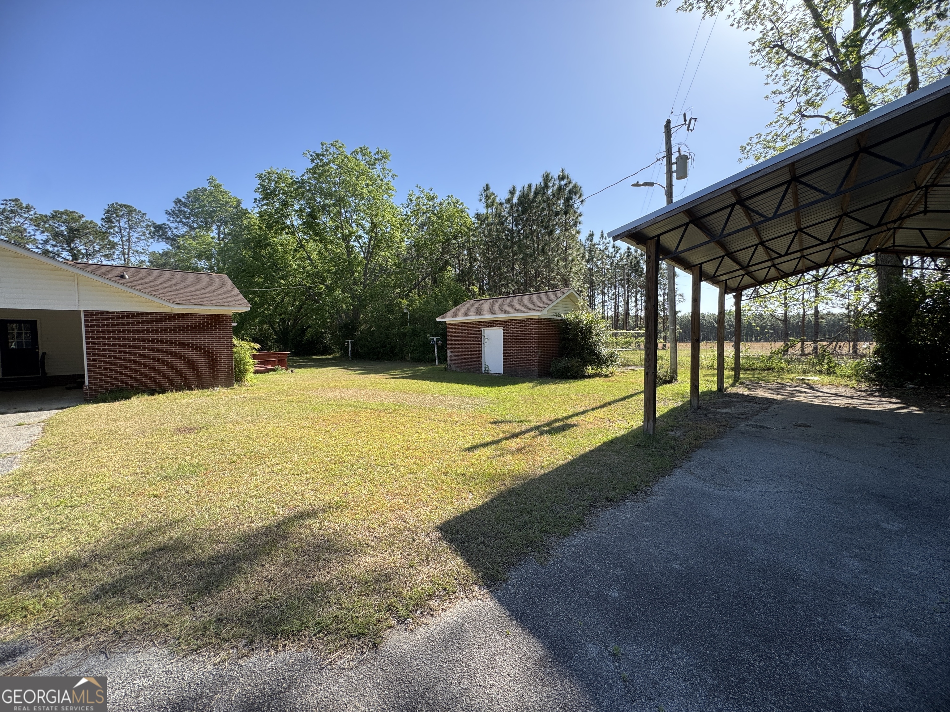 7290 Nevils Groveland Road Pembroke, GA 31321 - Photo 14 of 45 a view of a house with backyard and sitting area