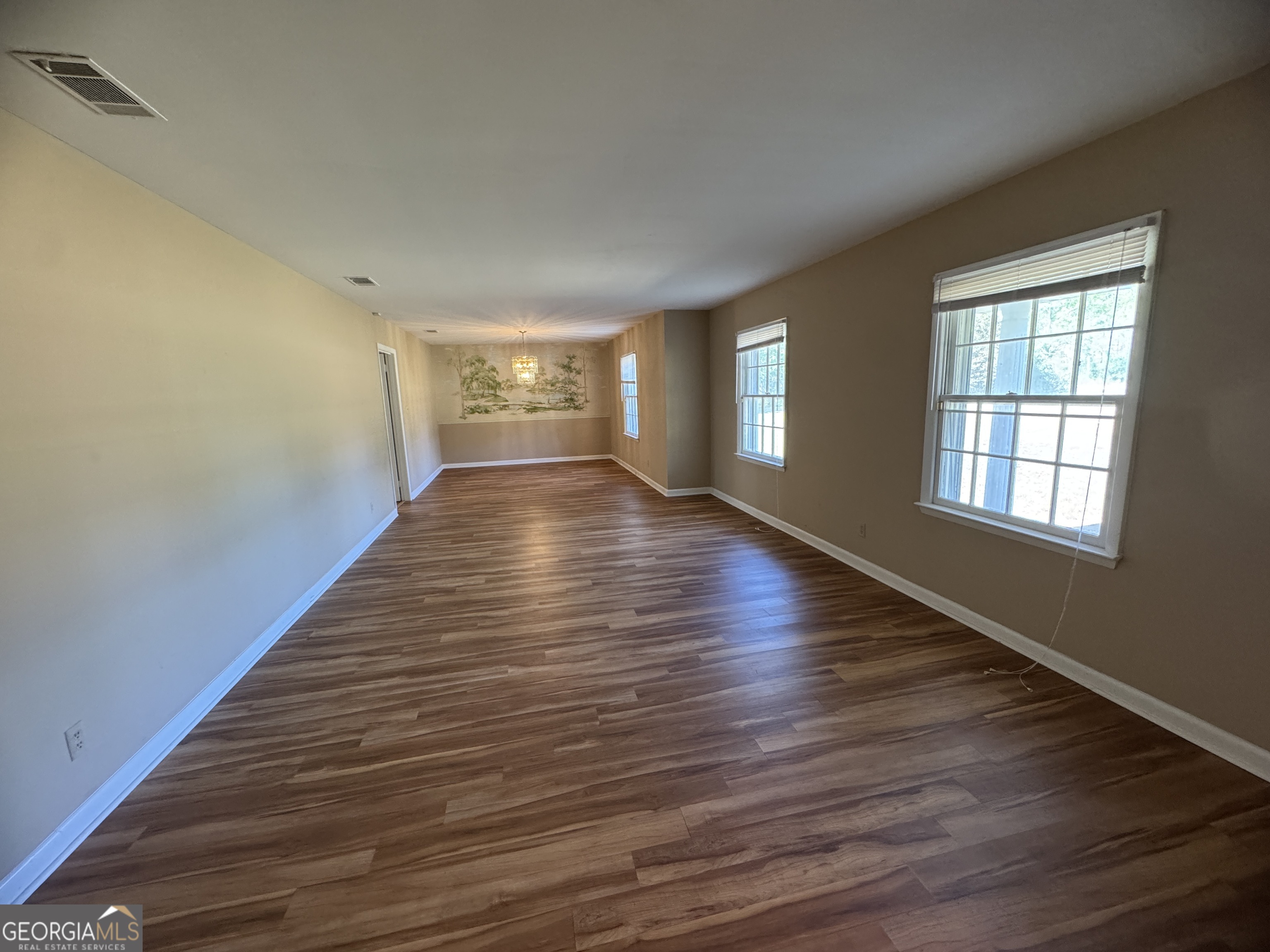 7290 Nevils Groveland Road Pembroke, GA 31321 - Photo 15 of 45 a view of an empty room with wooden floor and window