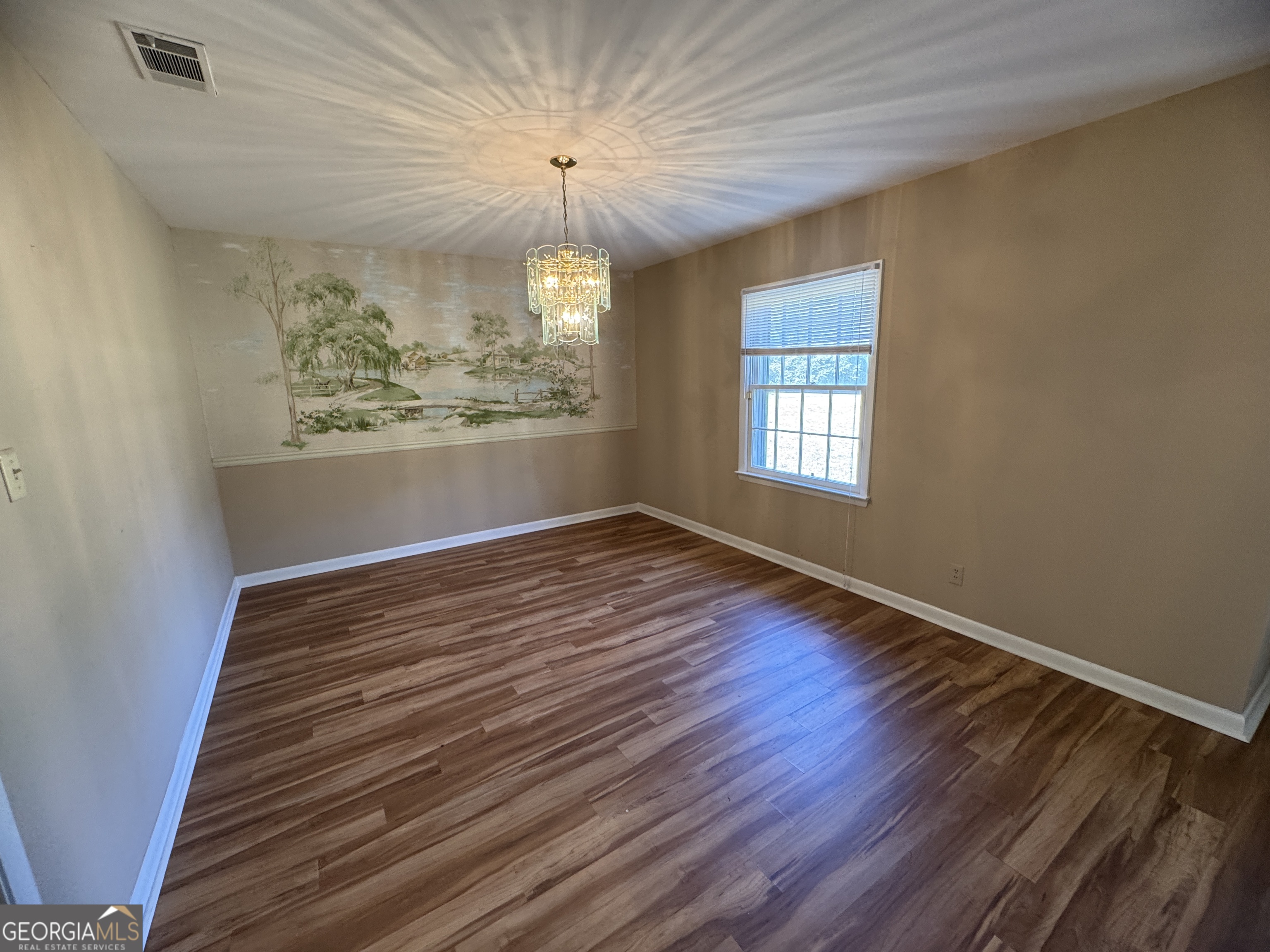 7290 Nevils Groveland Road Pembroke, GA 31321 - Photo 16 of 45 wooden floor in an empty room with a window