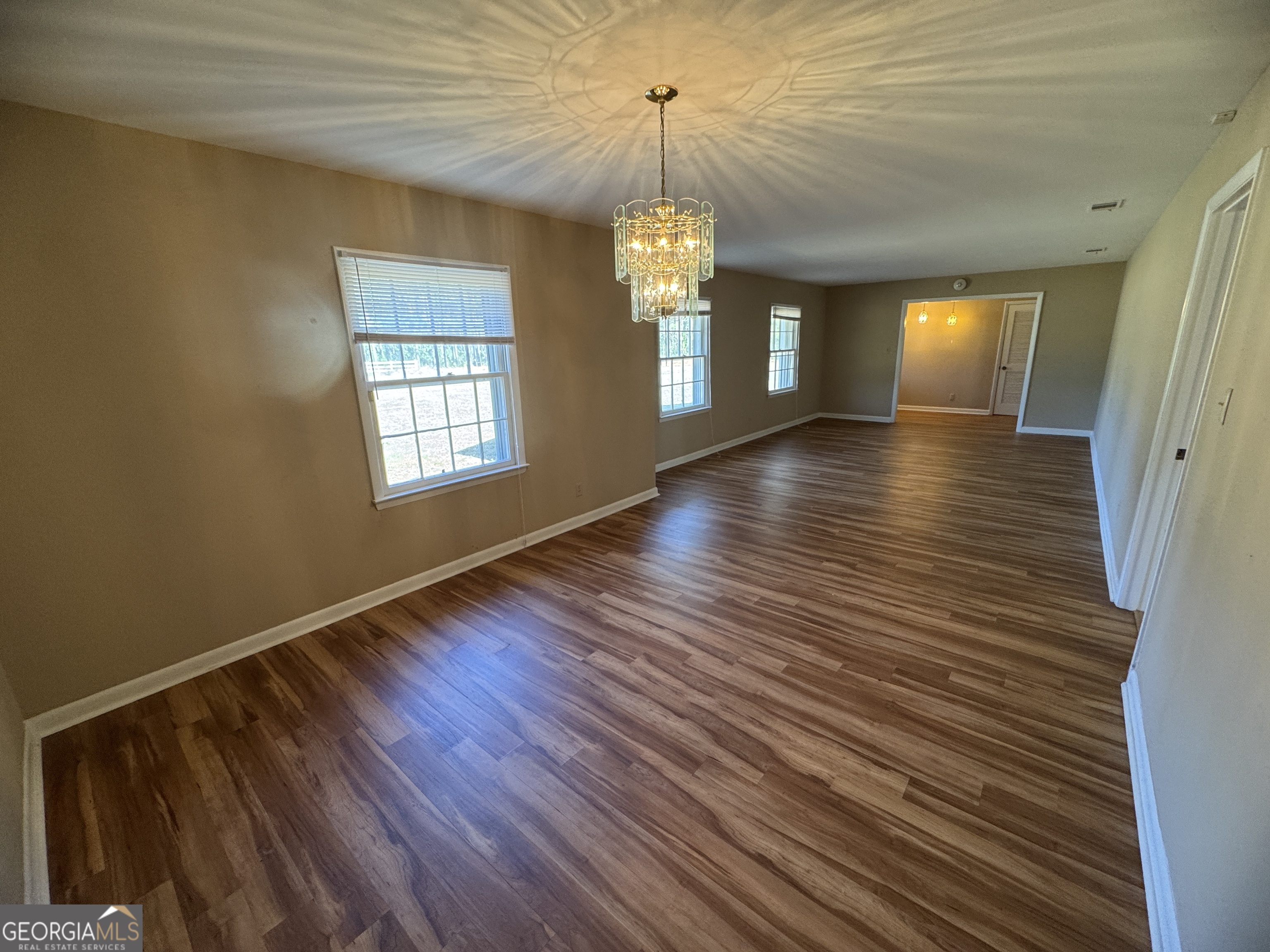 7290 Nevils Groveland Road Pembroke, GA 31321 - Photo 17 of 45 a view of a room with wooden floor and staircase