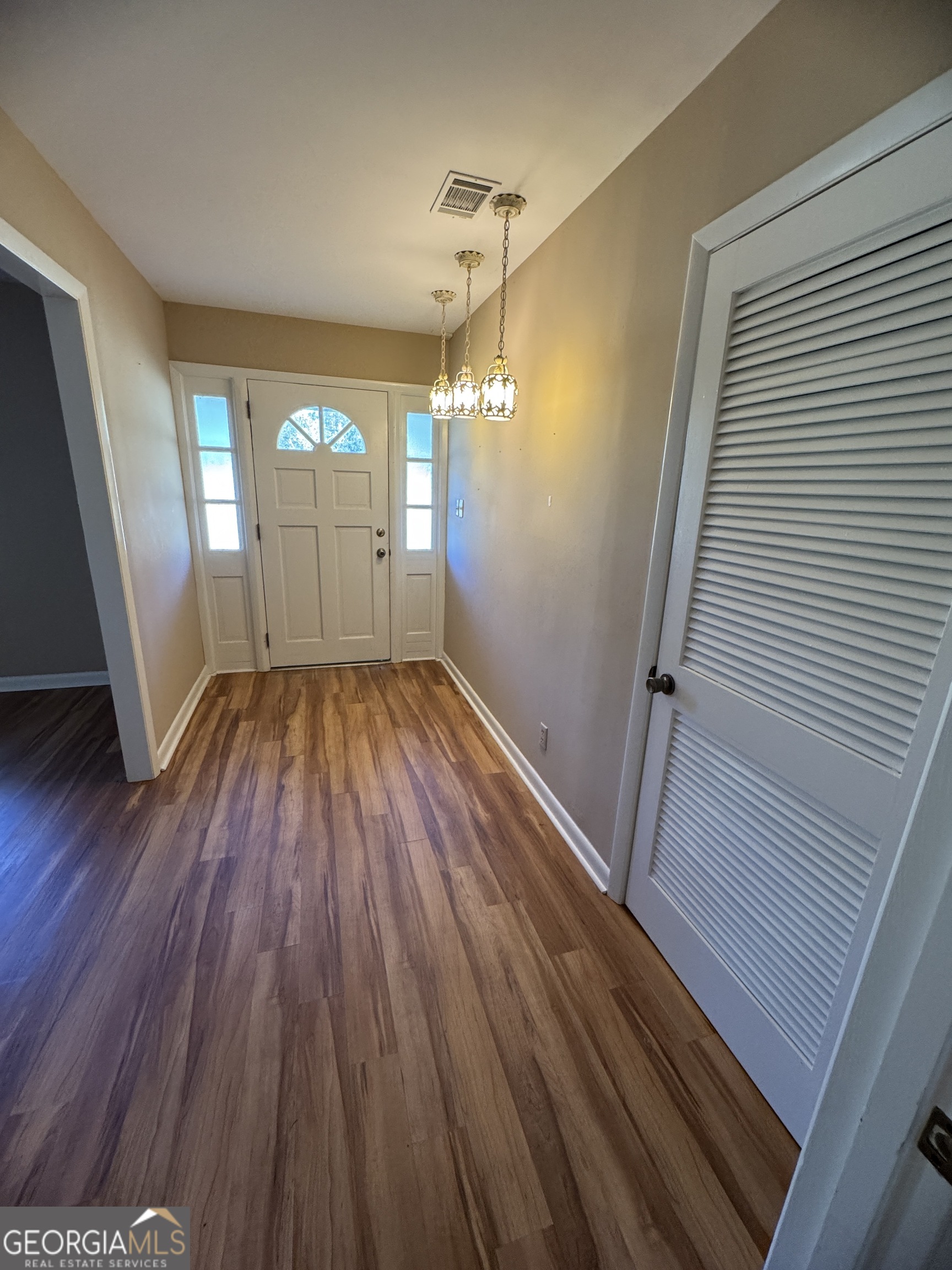 7290 Nevils Groveland Road Pembroke, GA 31321 - Photo 18 of 45 a view of empty room with wooden floor and fan