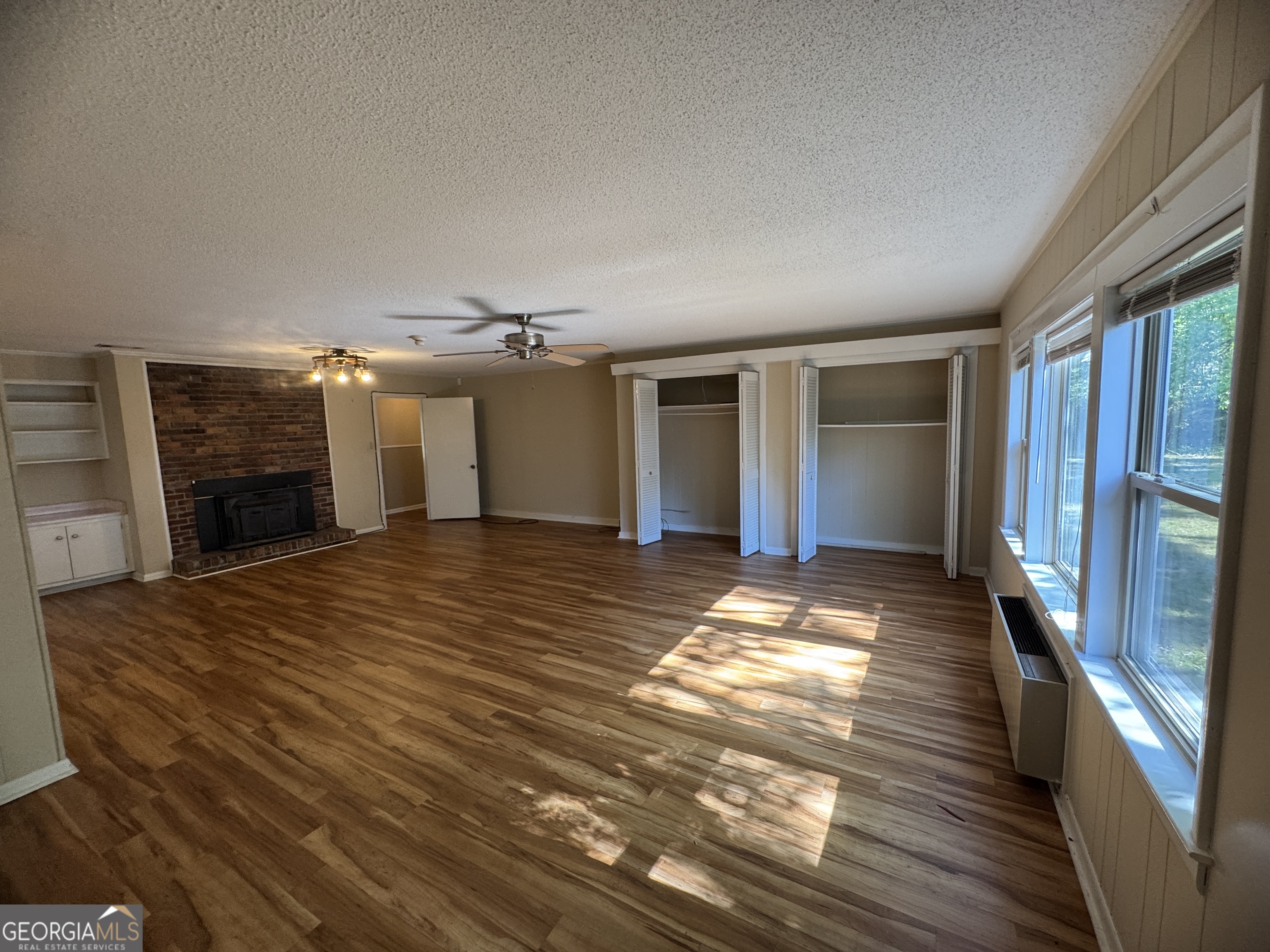 7290 Nevils Groveland Road Pembroke, GA 31321 - Photo 22 of 45 a view of a livingroom with wooden floor and a kitchen