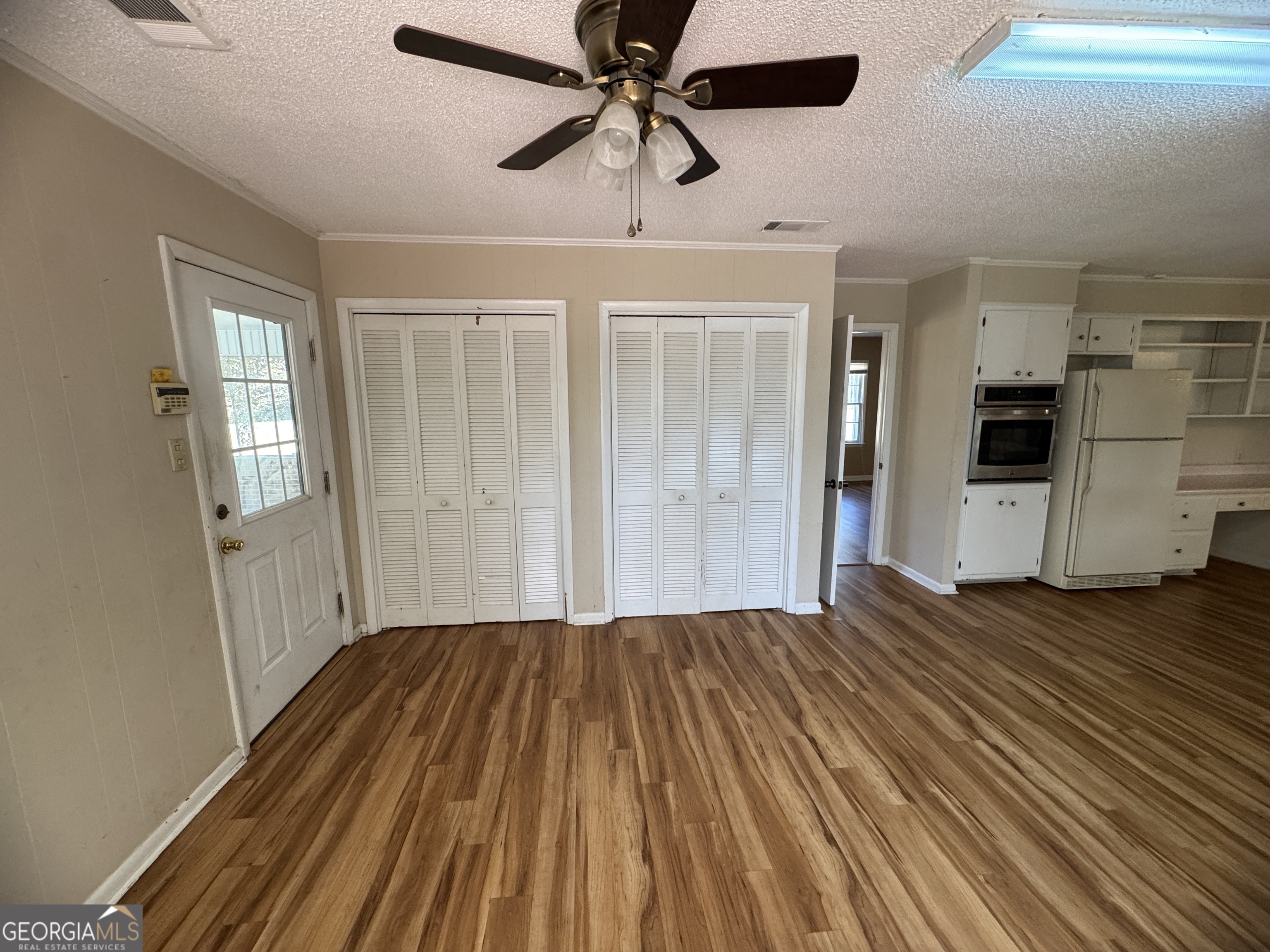 7290 Nevils Groveland Road Pembroke, GA 31321 - Photo 29 of 45 a view of a livingroom with a dishwasher cabinets and wooden floor