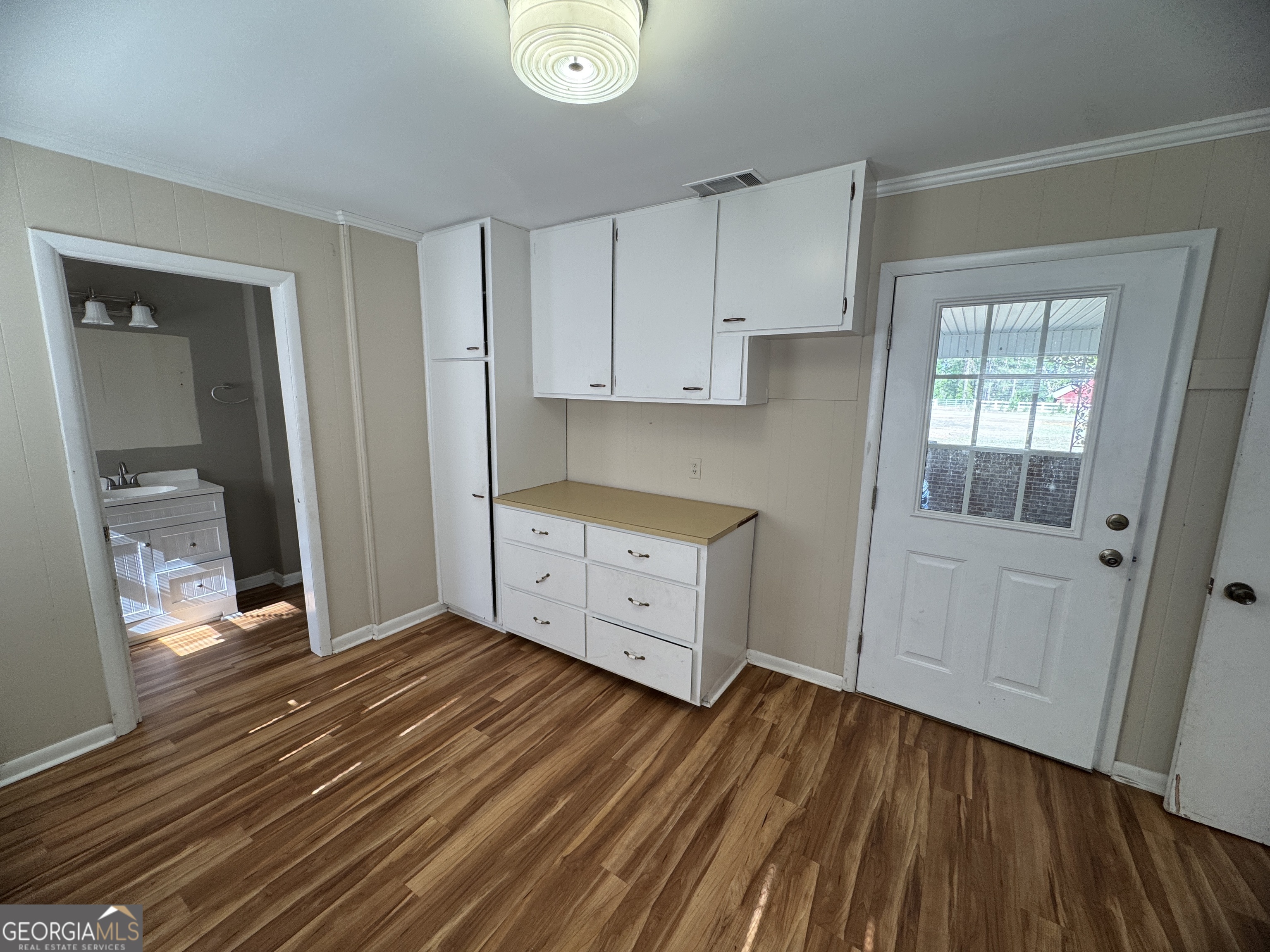 7290 Nevils Groveland Road Pembroke, GA 31321 - Photo 31 of 45 a view of a kitchen with wooden floor and a sink