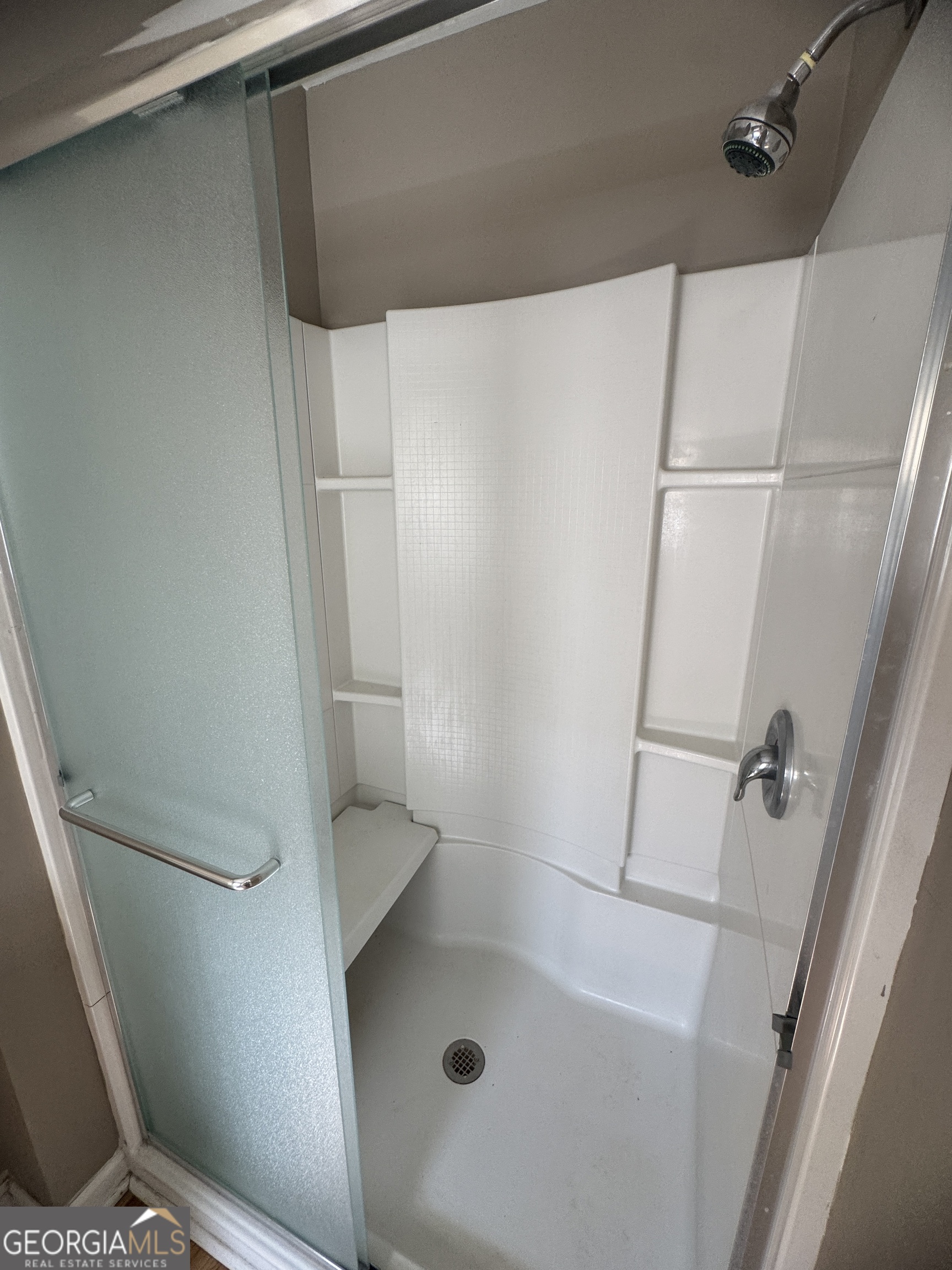 7290 Nevils Groveland Road Pembroke, GA 31321 - Photo 33 of 45 a bathroom with a glass door shower and toilet