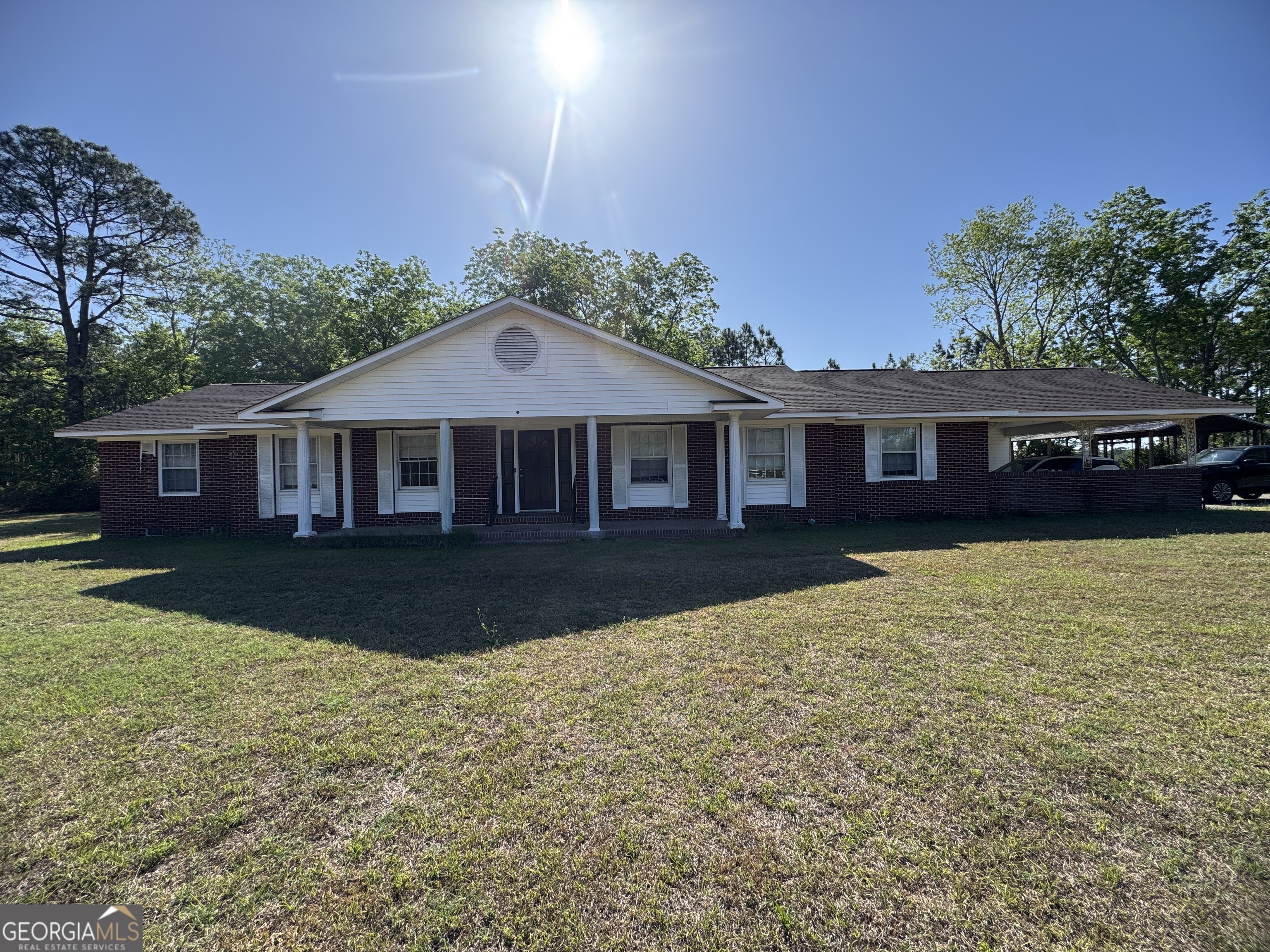 7290 Nevils Groveland Road Pembroke, GA 31321 - Photo 4 of 45 a front view of a house with a yard