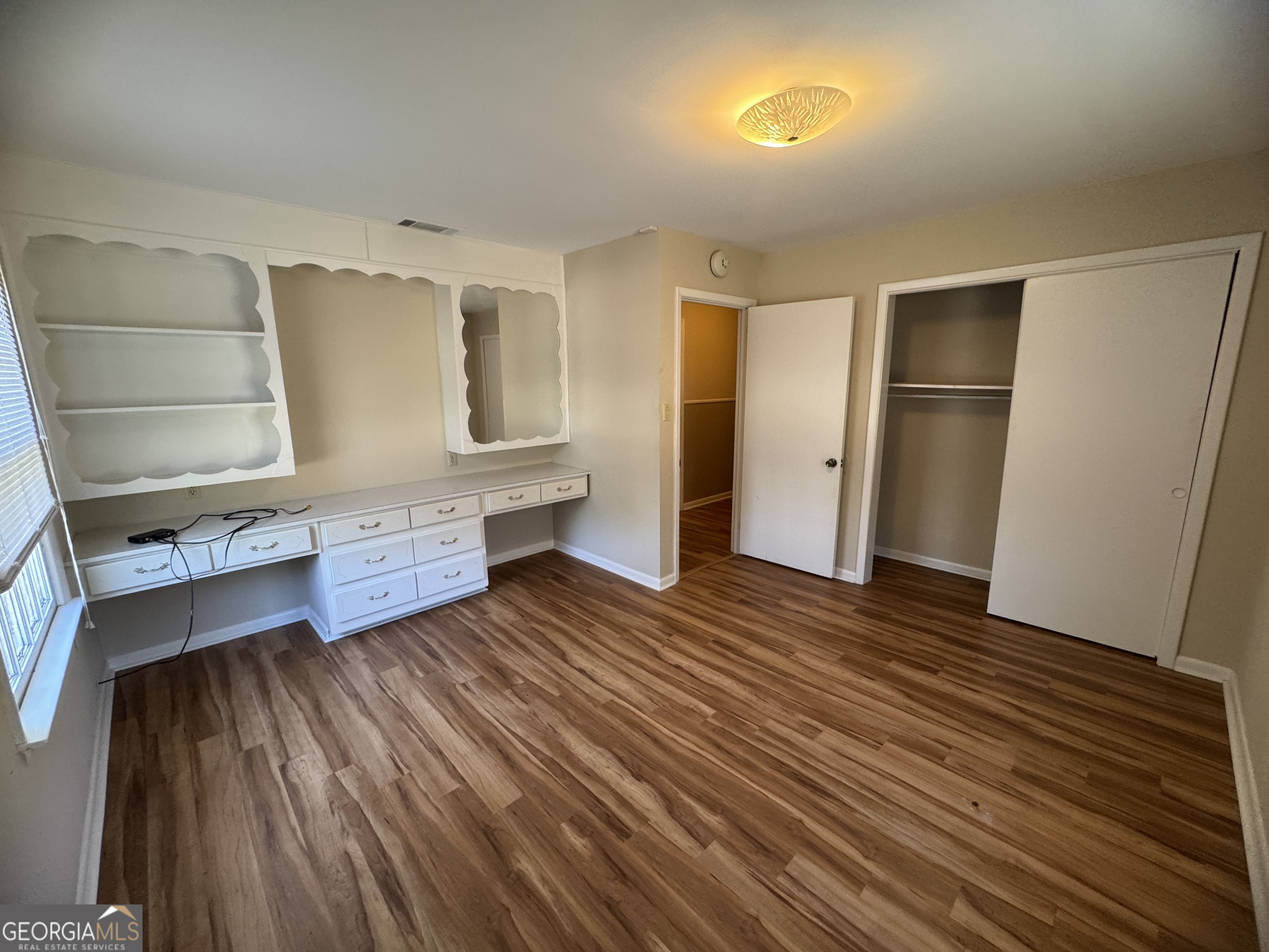 7290 Nevils Groveland Road Pembroke, GA 31321 - Photo 41 of 45 a view of an empty room with wooden floor and a window
