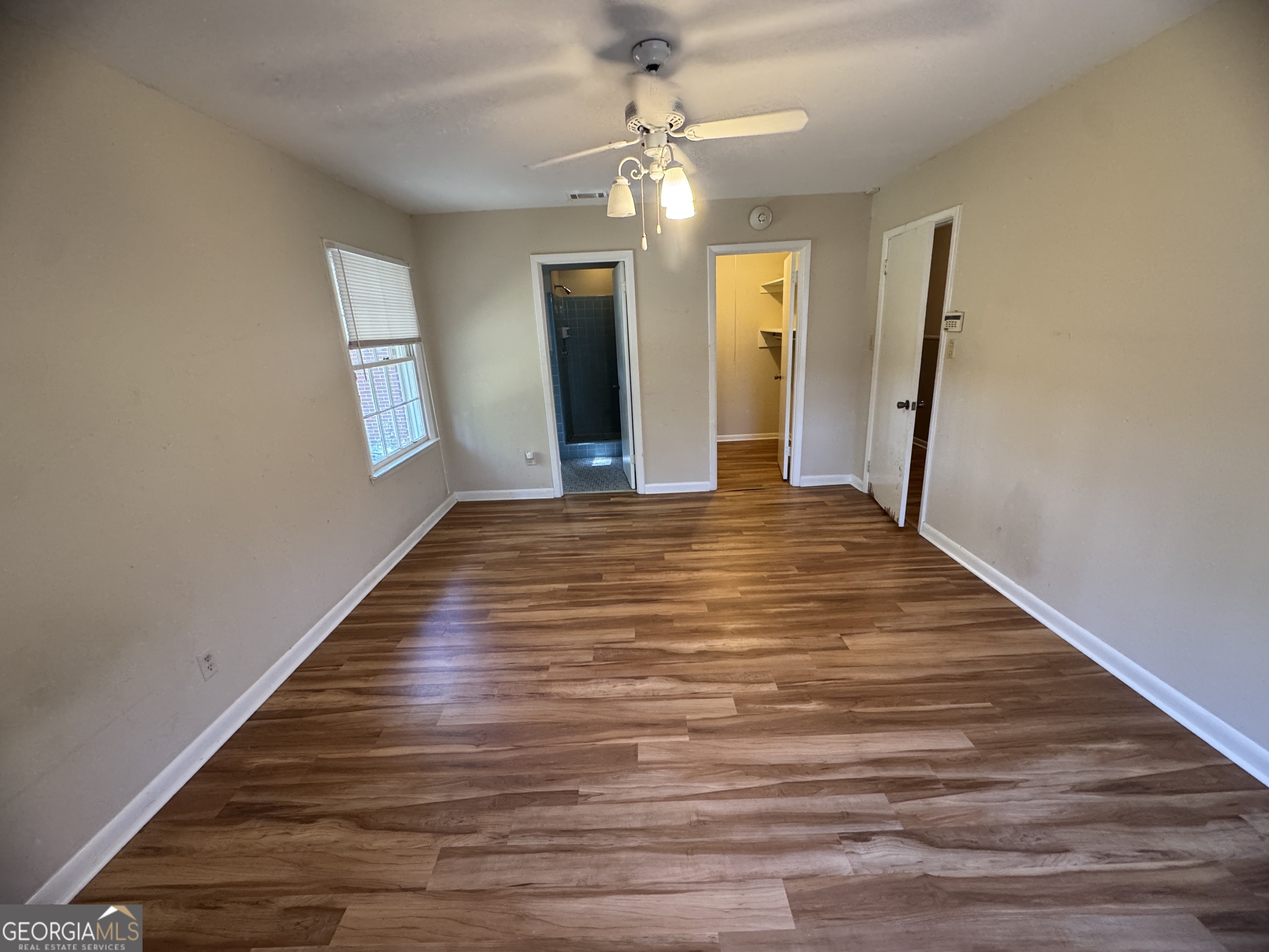 7290 Nevils Groveland Road Pembroke, GA 31321 - Photo 43 of 45 a big room with wooden floor and staircase