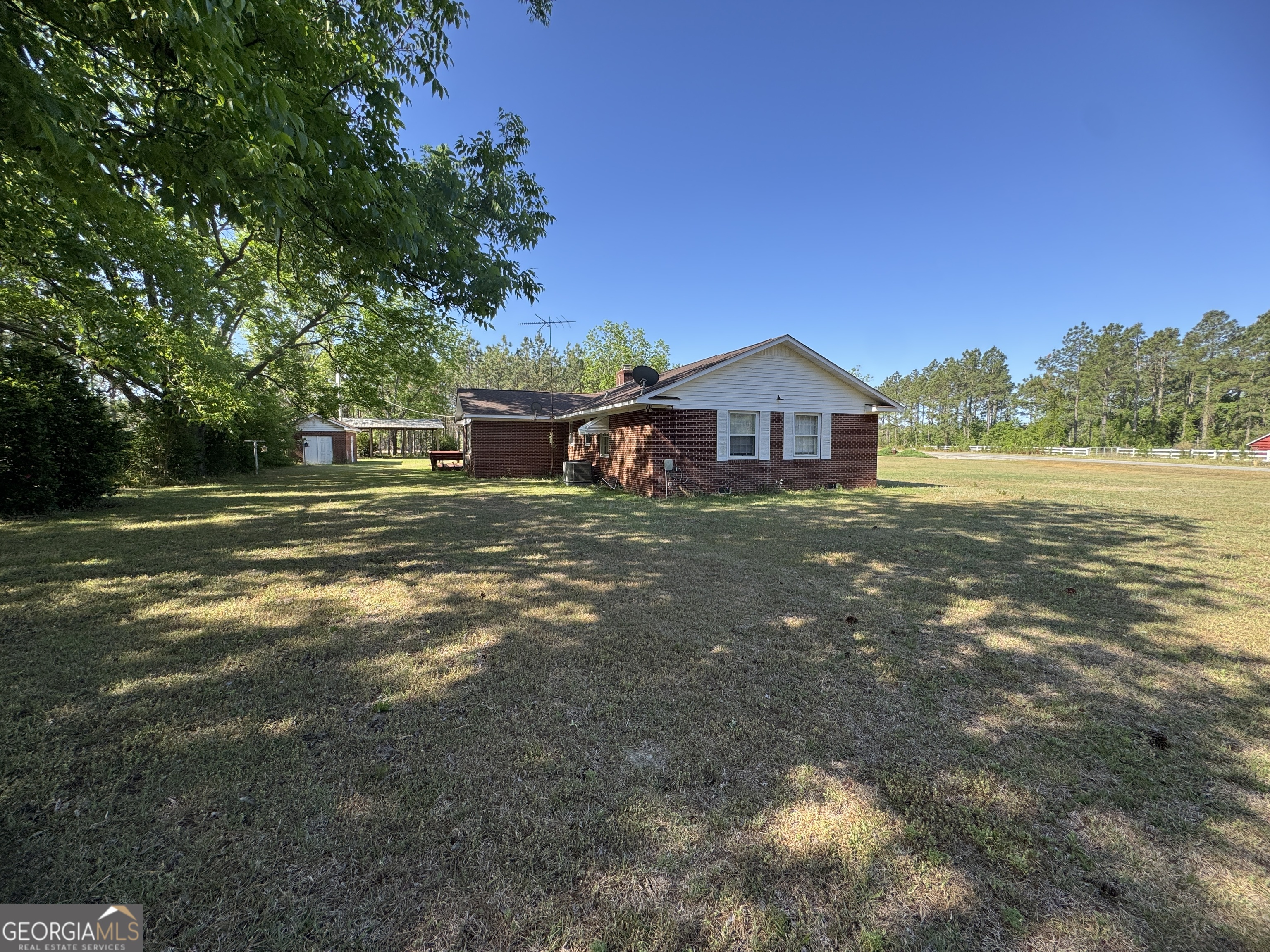 7290 Nevils Groveland Road Pembroke, GA 31321 - Photo 7 of 45 a view of a house with a big yard