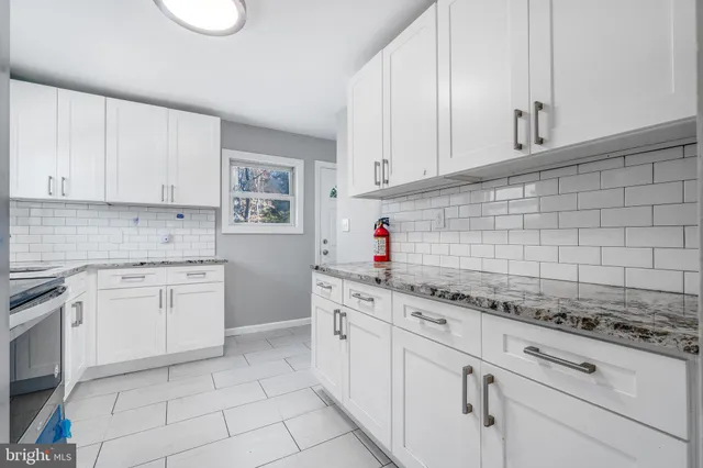 a kitchen with stainless steel appliances a stove microwave and refrigerator