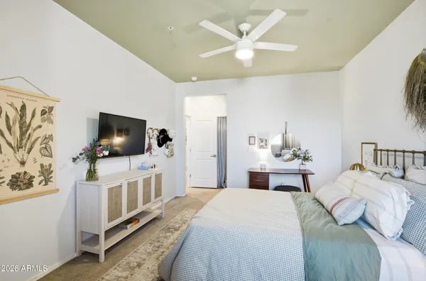 a bedroom with a bed and a flat screen tv