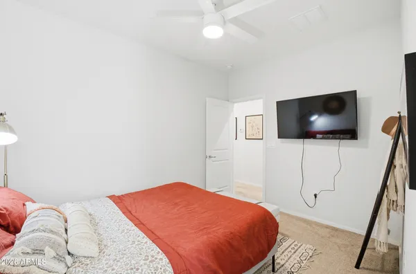 a bedroom with a bed and a flat screen tv