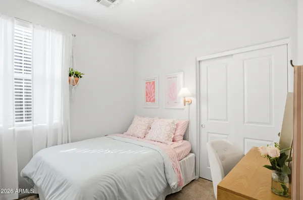 a bedroom with a bed and a window