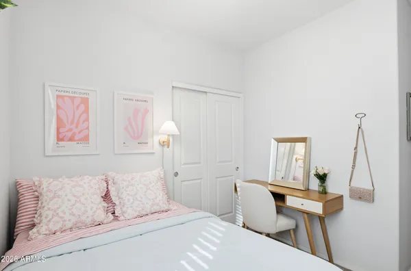 a bedroom with a bed and a chair