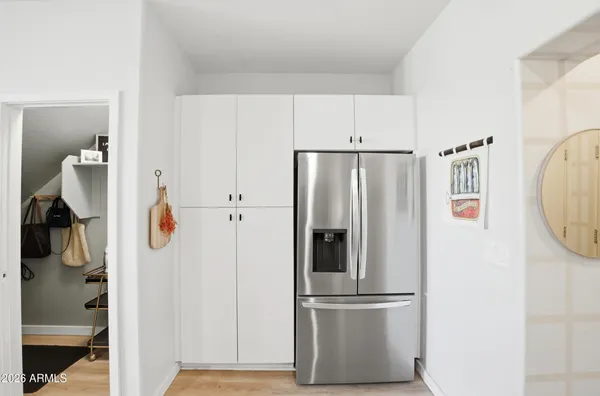 a metallic refrigerator freezer sitting in a kitchen