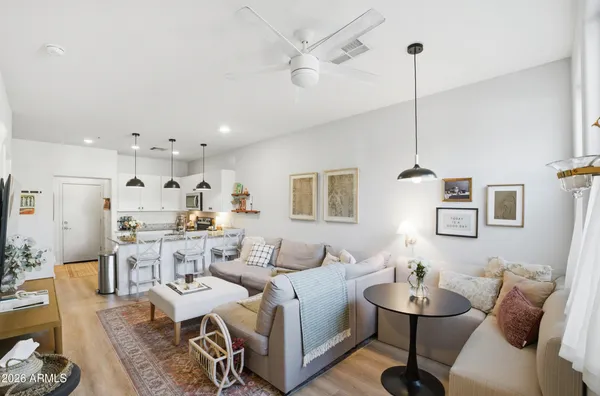 a living room with lots of furniture and a chandelier