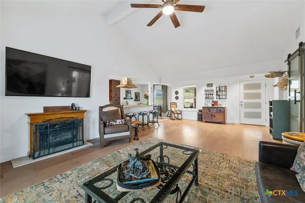 a view of a livingroom with furniture and a window