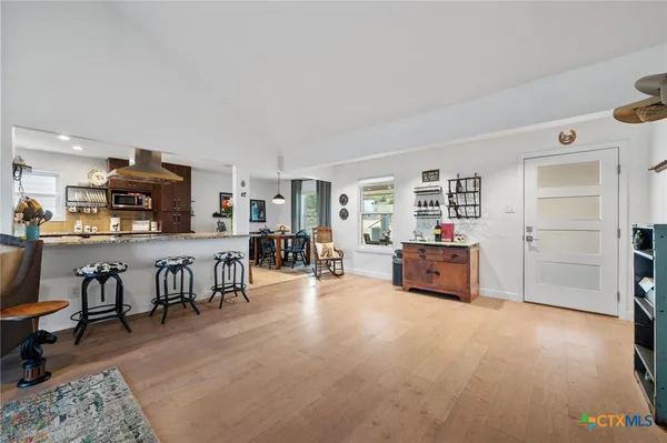 a large kitchen with stainless steel appliances kitchen island granite countertop a large stove top oven and cabinets