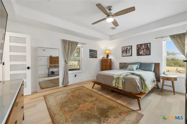 a bedroom with a bed and a flat screen tv