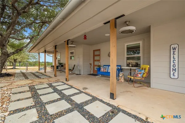 a view of a porch with a table and chairs