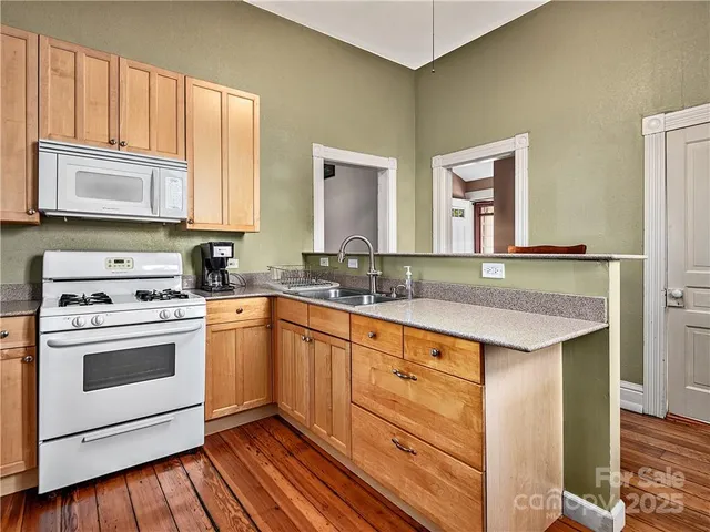a kitchen with a sink stove and refrigerator