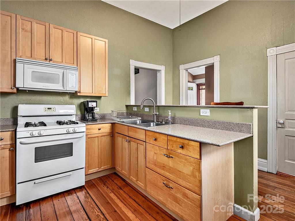 21 Pearl Street Asheville, NC 28801 - Photo 6 of 26 a kitchen with a sink stove and refrigerator