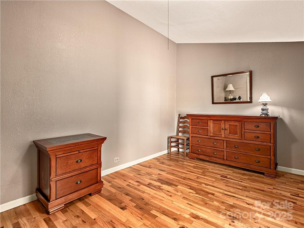 21 Pearl Street Asheville, NC 28801 - Photo 10 of 26 a room with a bed and a dresser
