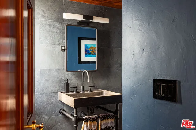 a view of a bathroom with a sink and mirror