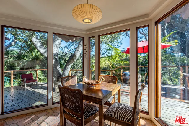a view of a dining room with furniture wooden floor and a floor to ceiling window