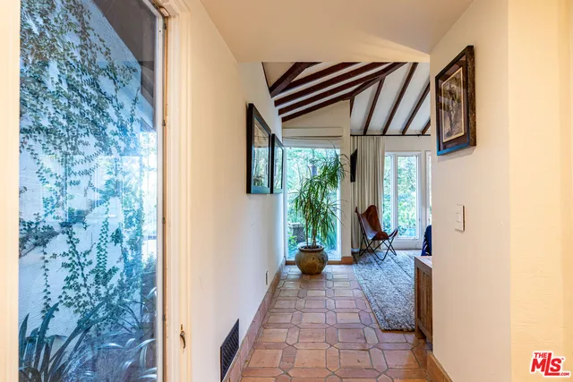 a bedroom with a bed and a large window with outer view