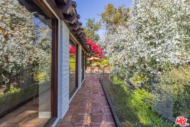 a front view of a house with yard and balcony