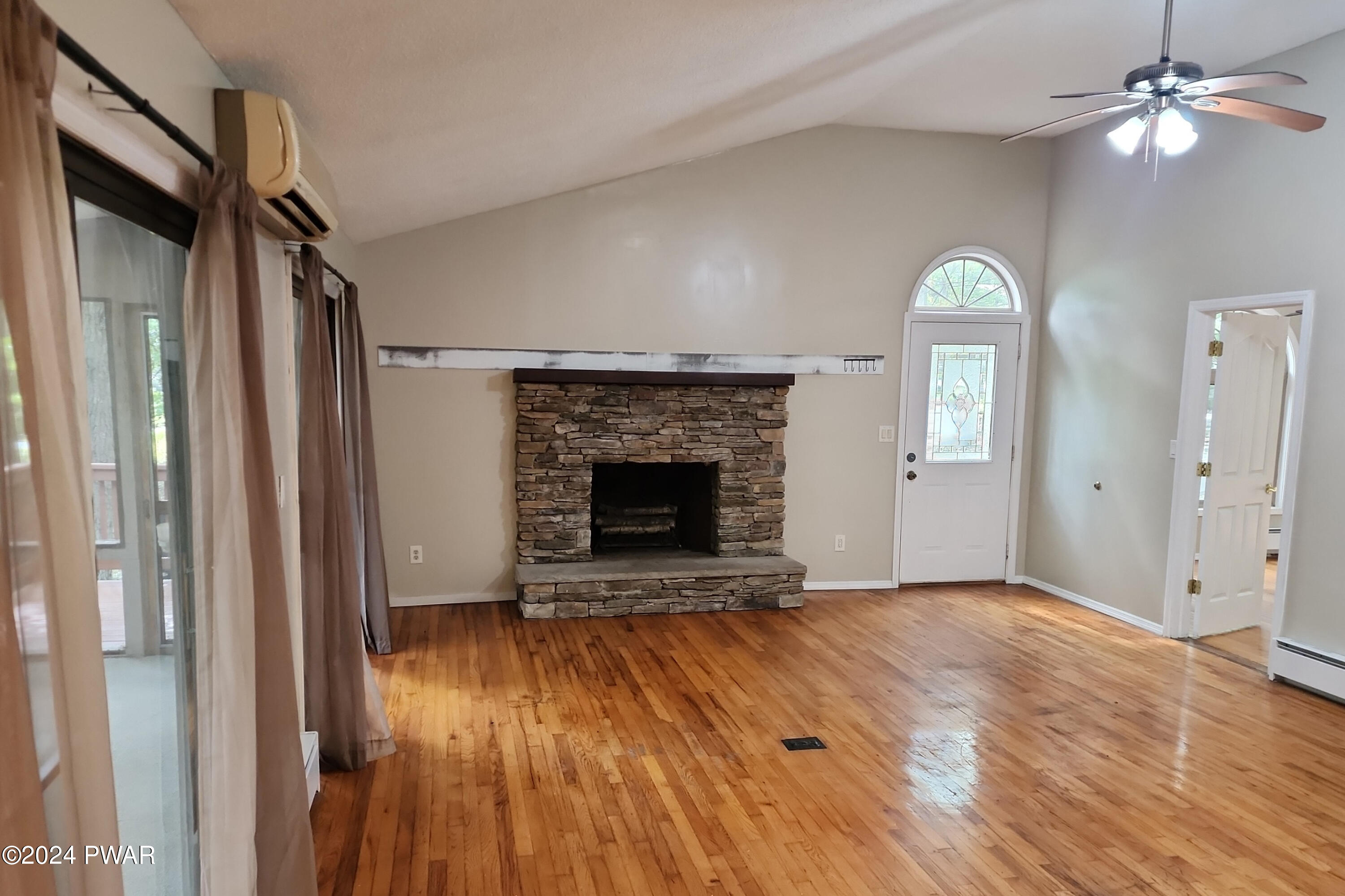 107 Rodeo Lane Hawley, PA 18428 - Photo 8 of 29 a view of an empty room with a fireplace and a window