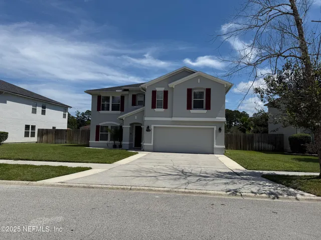 a front view of house with yard and green space