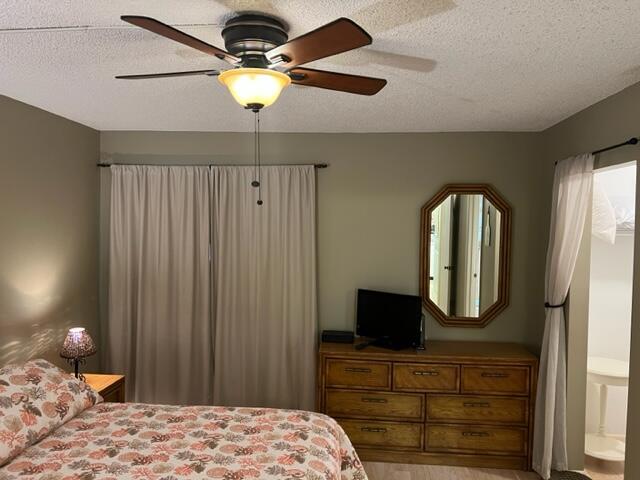 1605 Highway 1, Unit E203 Jupiter, FL 33477 - Photo 17 of 28 a bedroom with a bed and a mirror on dresser