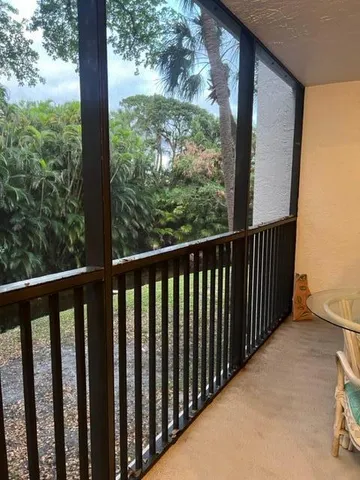 a view of a wooden balcony with yard