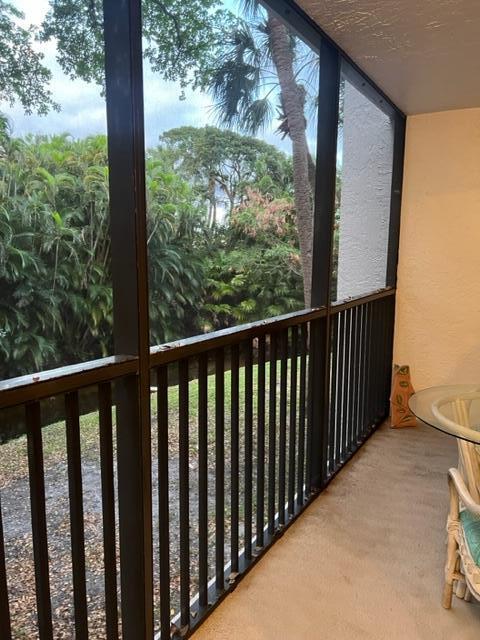 1605 Highway 1, Unit E203 Jupiter, FL 33477 - Photo 23 of 28 a view of a wooden balcony with yard