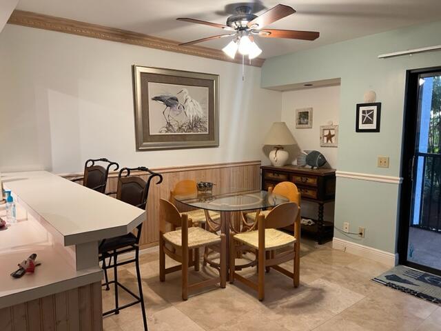 1605 Highway 1, Unit E203 Jupiter, FL 33477 - Photo 10 of 28 a view of a dining room with furniture and a chandelier fan