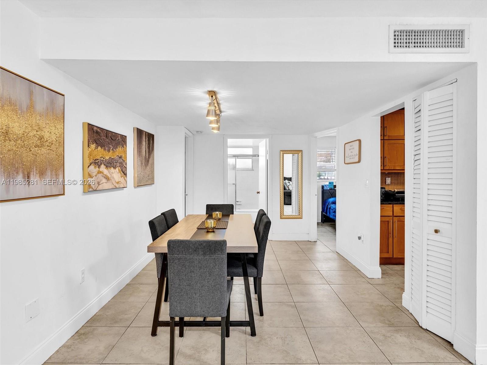 1236 Alton Road, Unit 304 Miami Beach, FL 33139 - Photo 9 of 28 a dining room with furniture and window