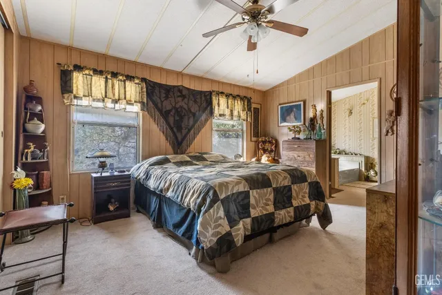 a spacious bedroom with a bed and a chandelier
