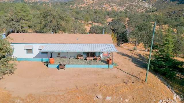 aerial view of a house with yard and sitting area
