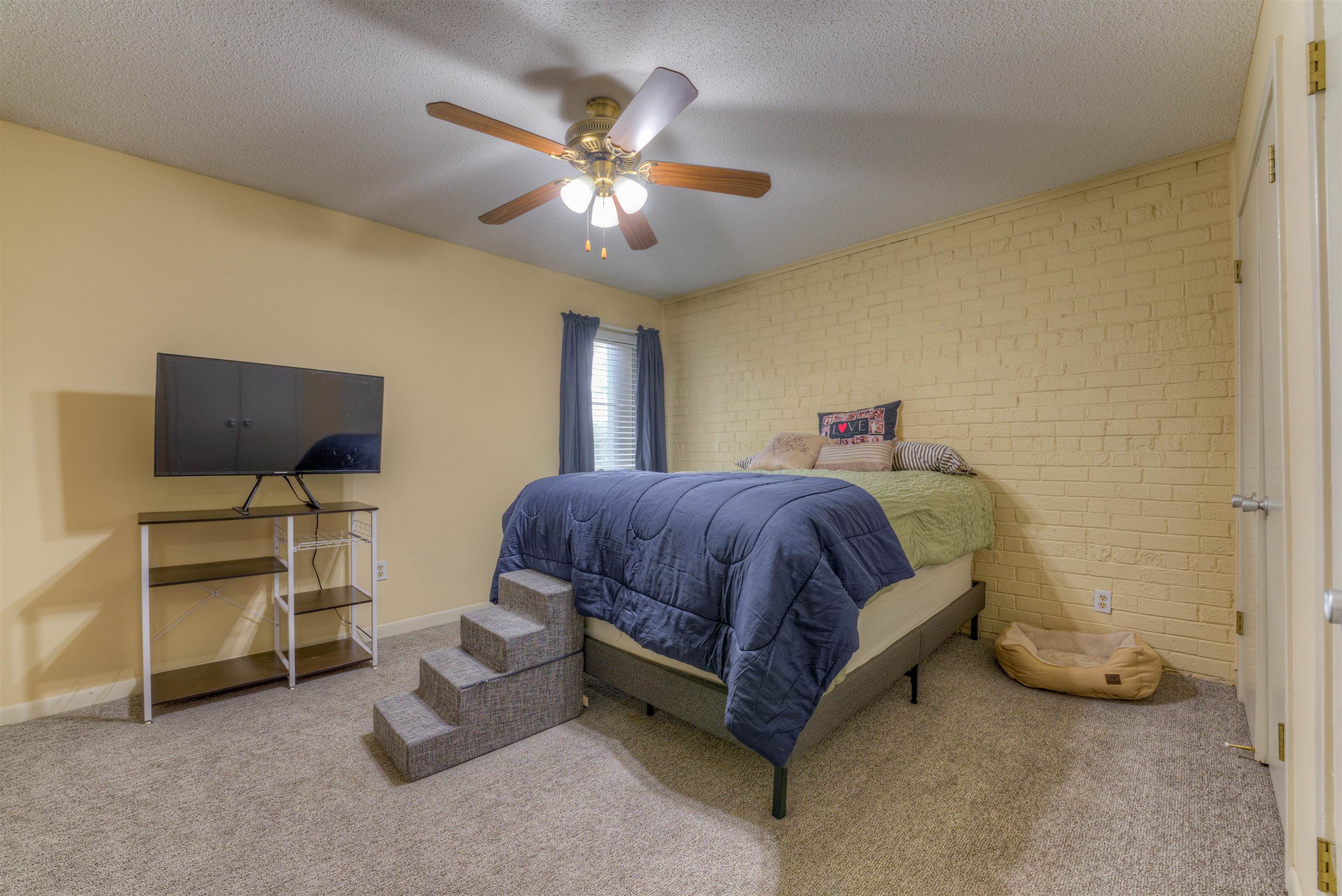 997 June Road Memphis, TN 38119 - Photo 16 of 30 a spacious bedroom with a bed and a chandelier