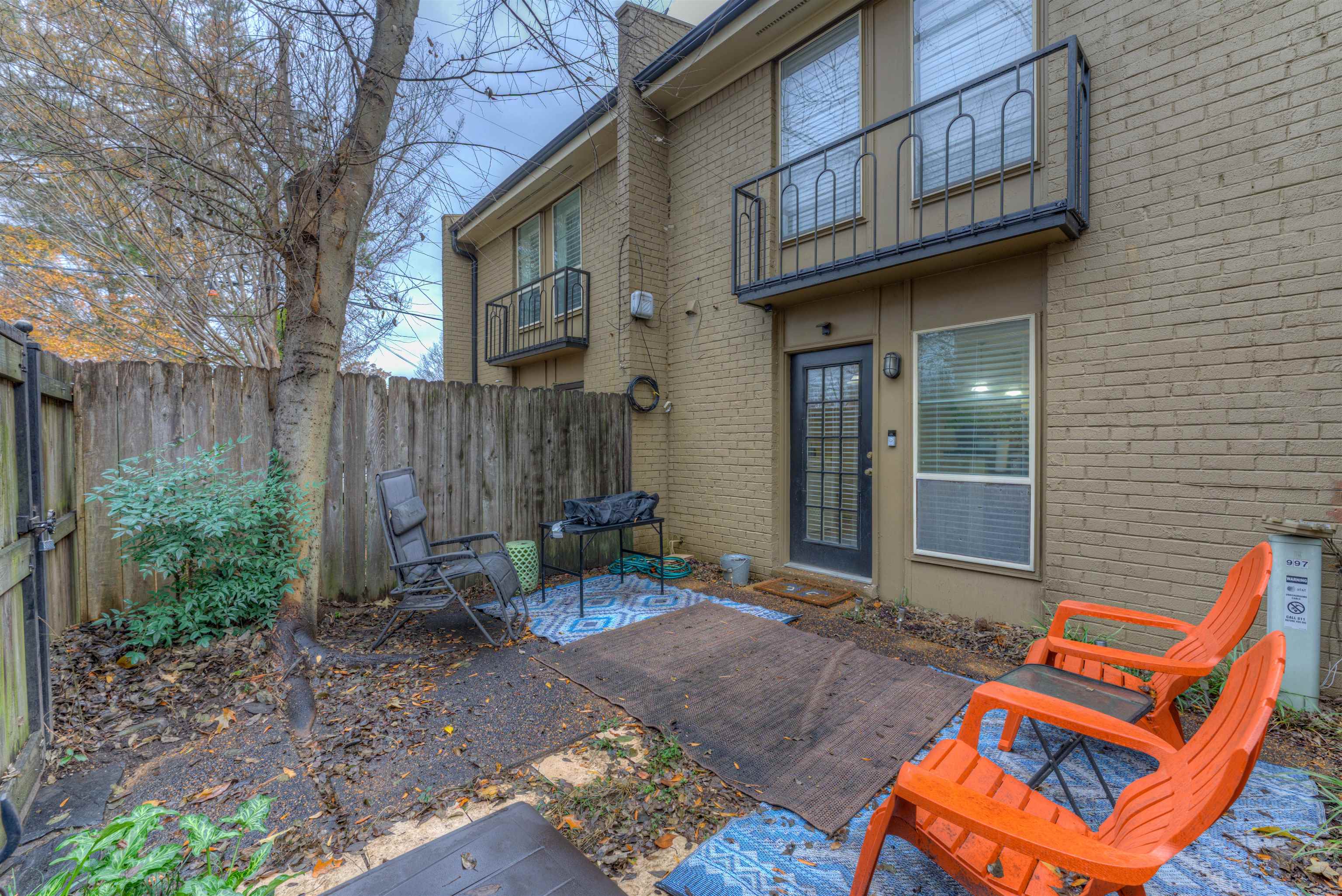 997 June Road Memphis, TN 38119 - Photo 19 of 30 a backyard of a house with chairs and wooden fence