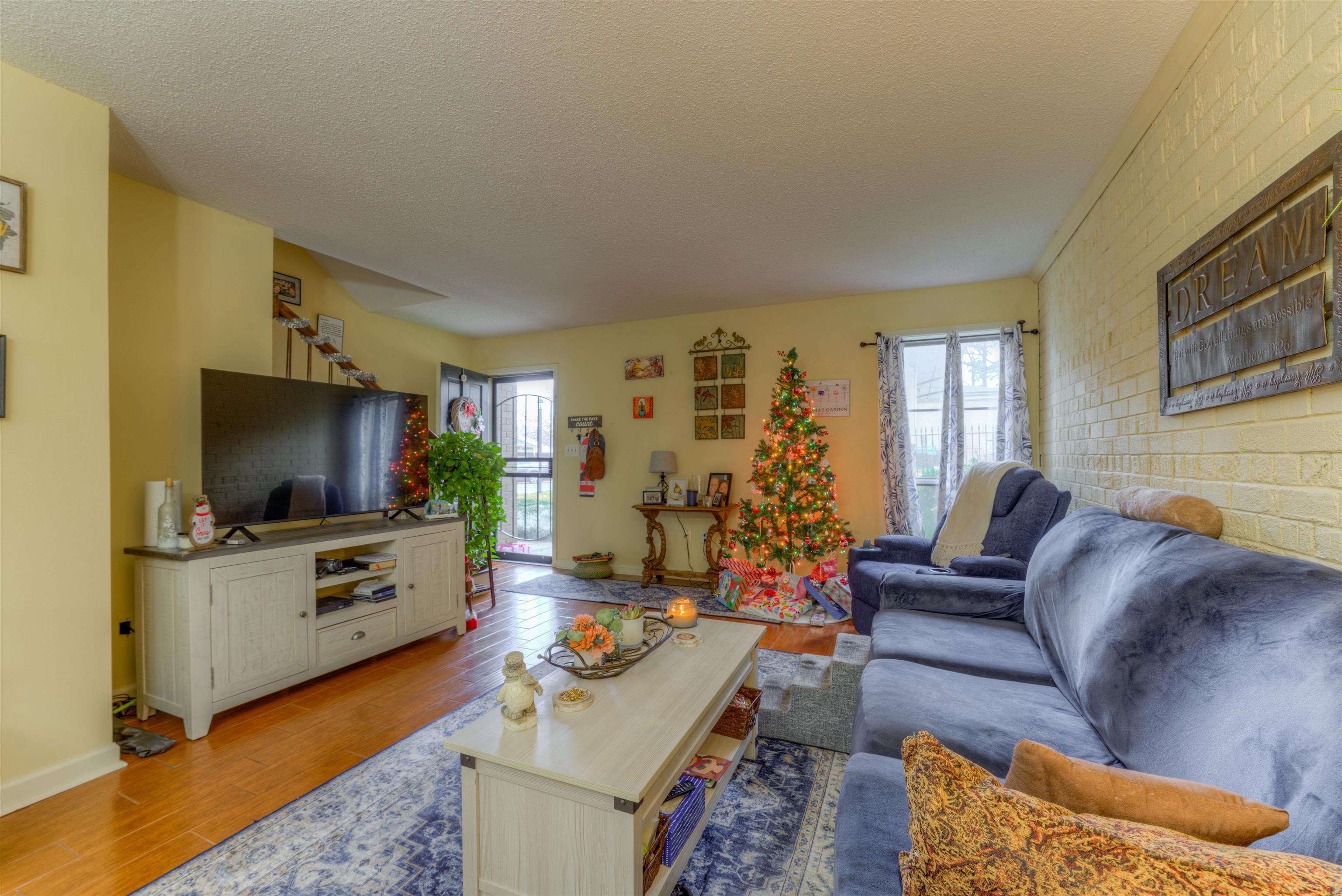 997 June Road Memphis, TN 38119 - Photo 4 of 30 a living room with furniture and a flat screen tv