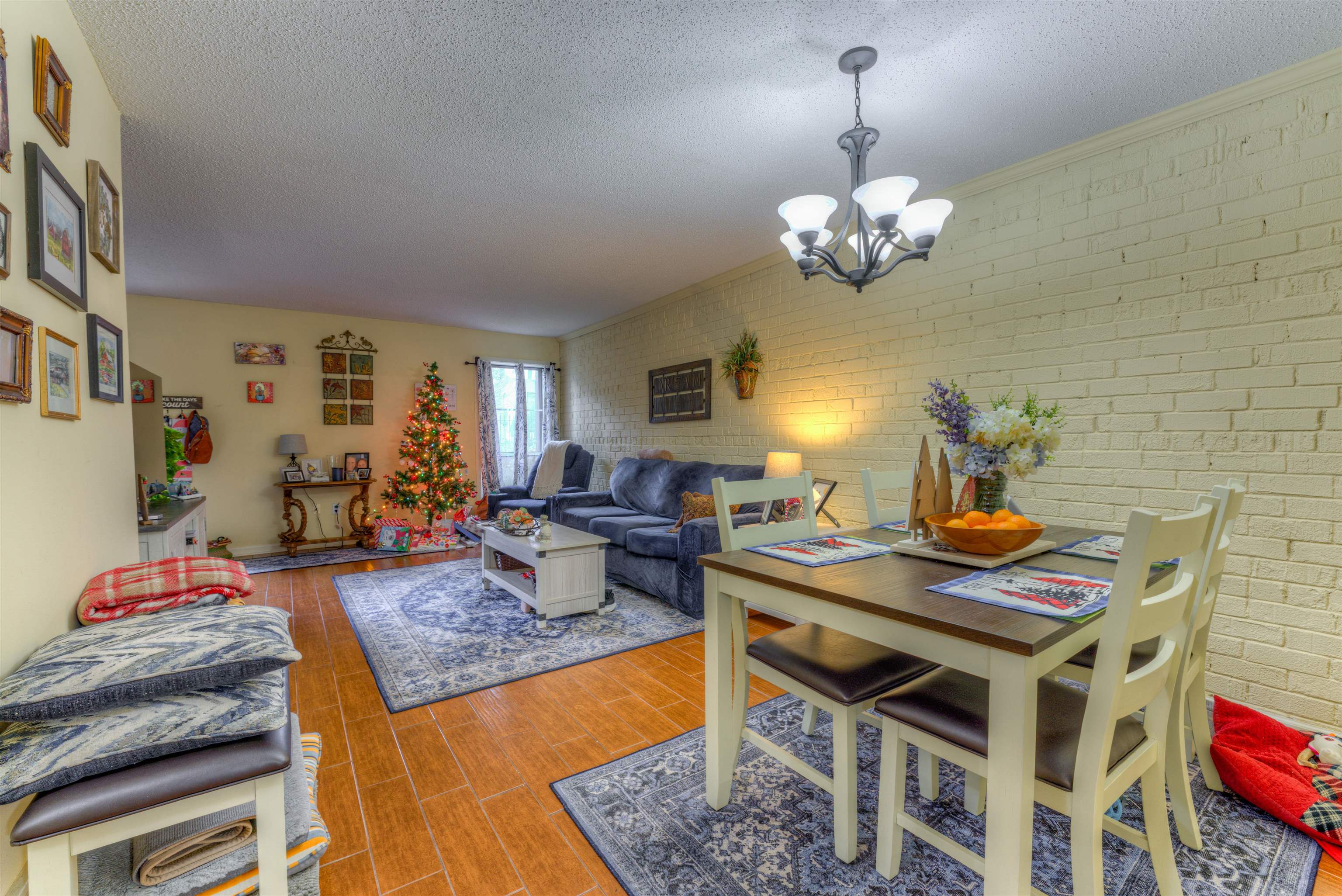 997 June Road Memphis, TN 38119 - Photo 7 of 30 a view of a dining room with furniture a chandelier and wooden floor