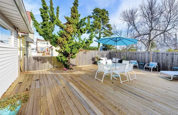 a view of a patio with a table chairs and a umbrella