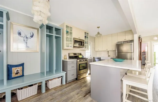 a kitchen with kitchen island a refrigerator stove and sink