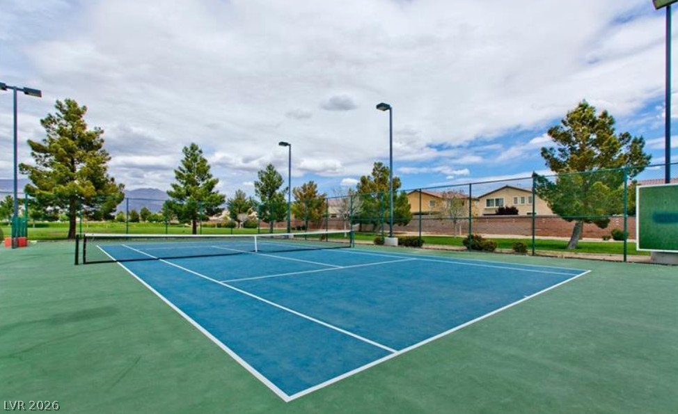 6405 North Raptor Court North Las Vegas, NV 89084 - Photo 59 of 66 An all-weather tennis court offers year-round recreation, complete with professional-grade lighting for evening play.
